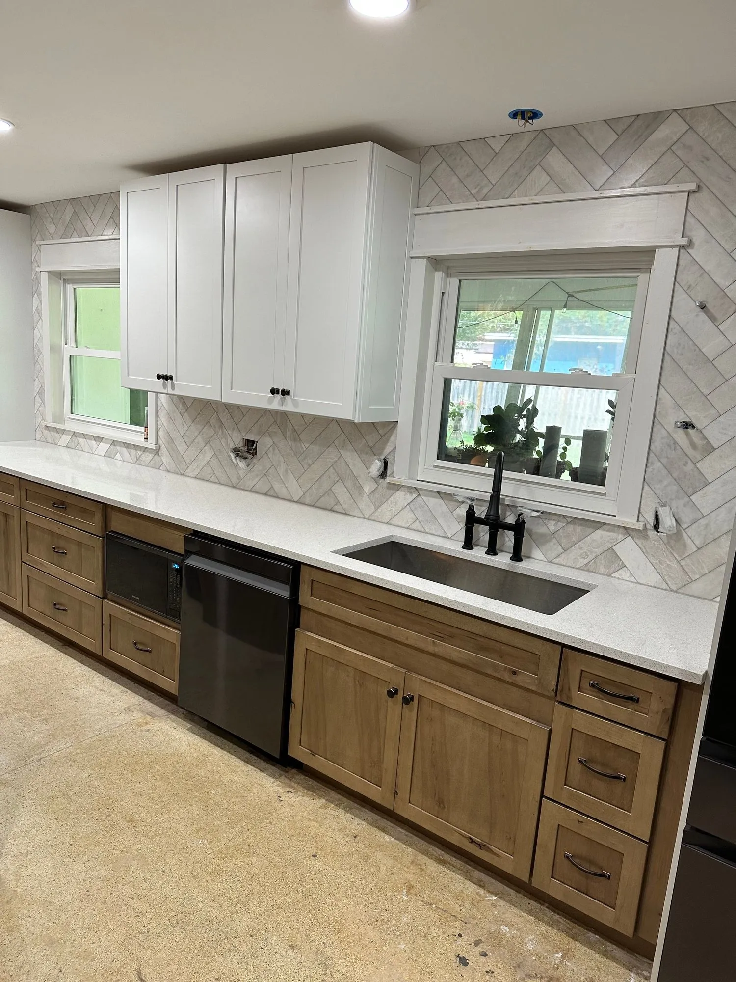 High-end Florida kitchen remodel with white shaker cabinets and quartz island at golden hour