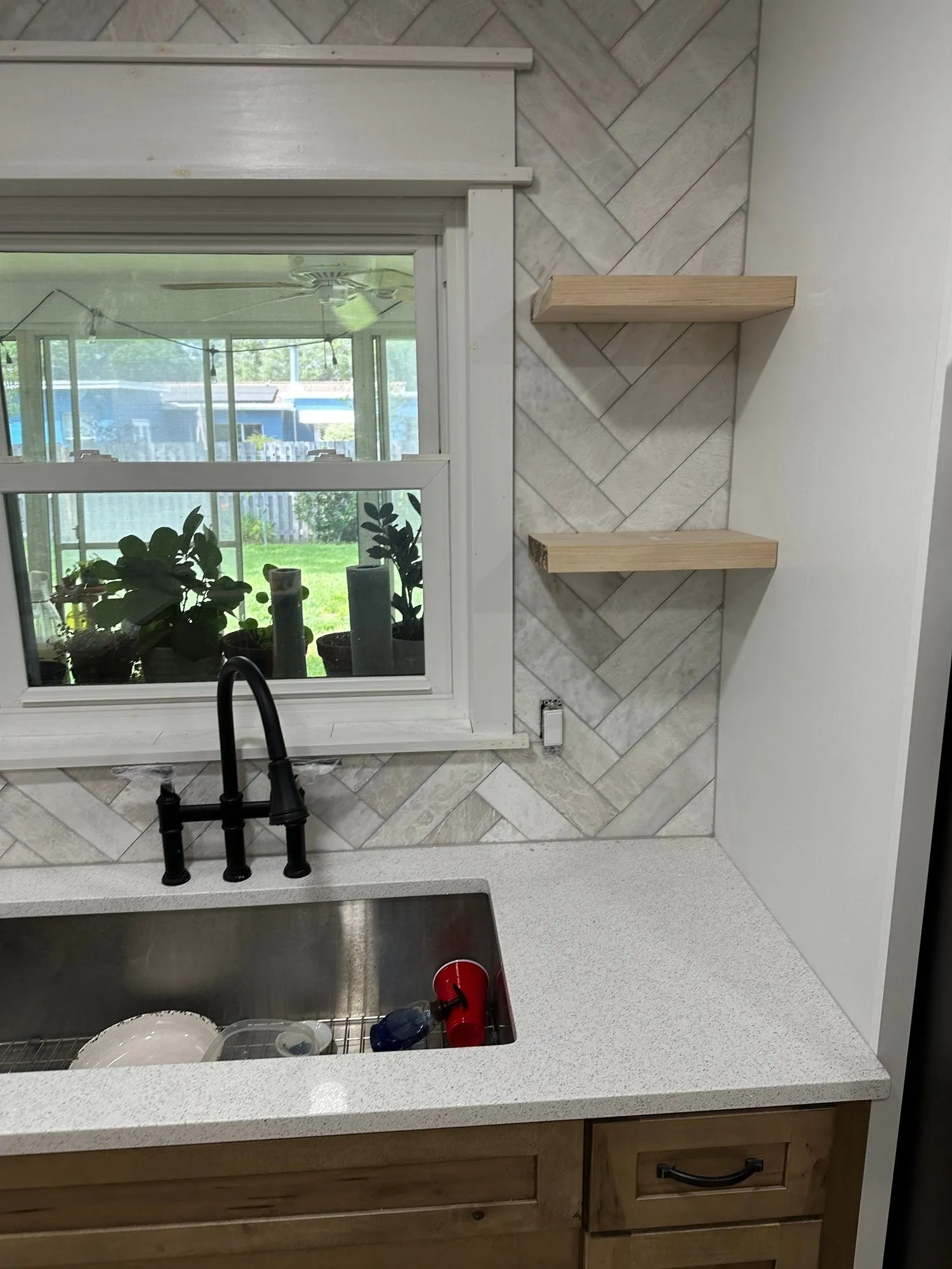White kitchen remodel with marble counters and brass hardware