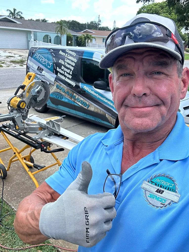 Patrick Flanery, owner of Patrick's Home Remodeling, on a job site with his work van