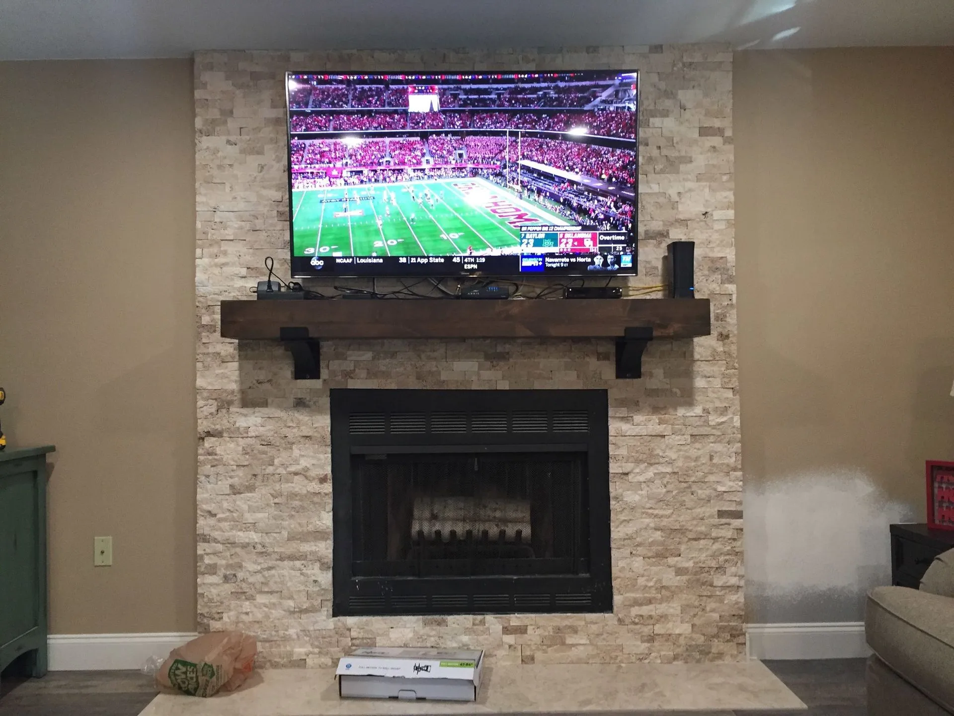 Fireplace remodel with custom mantel and stone veneer