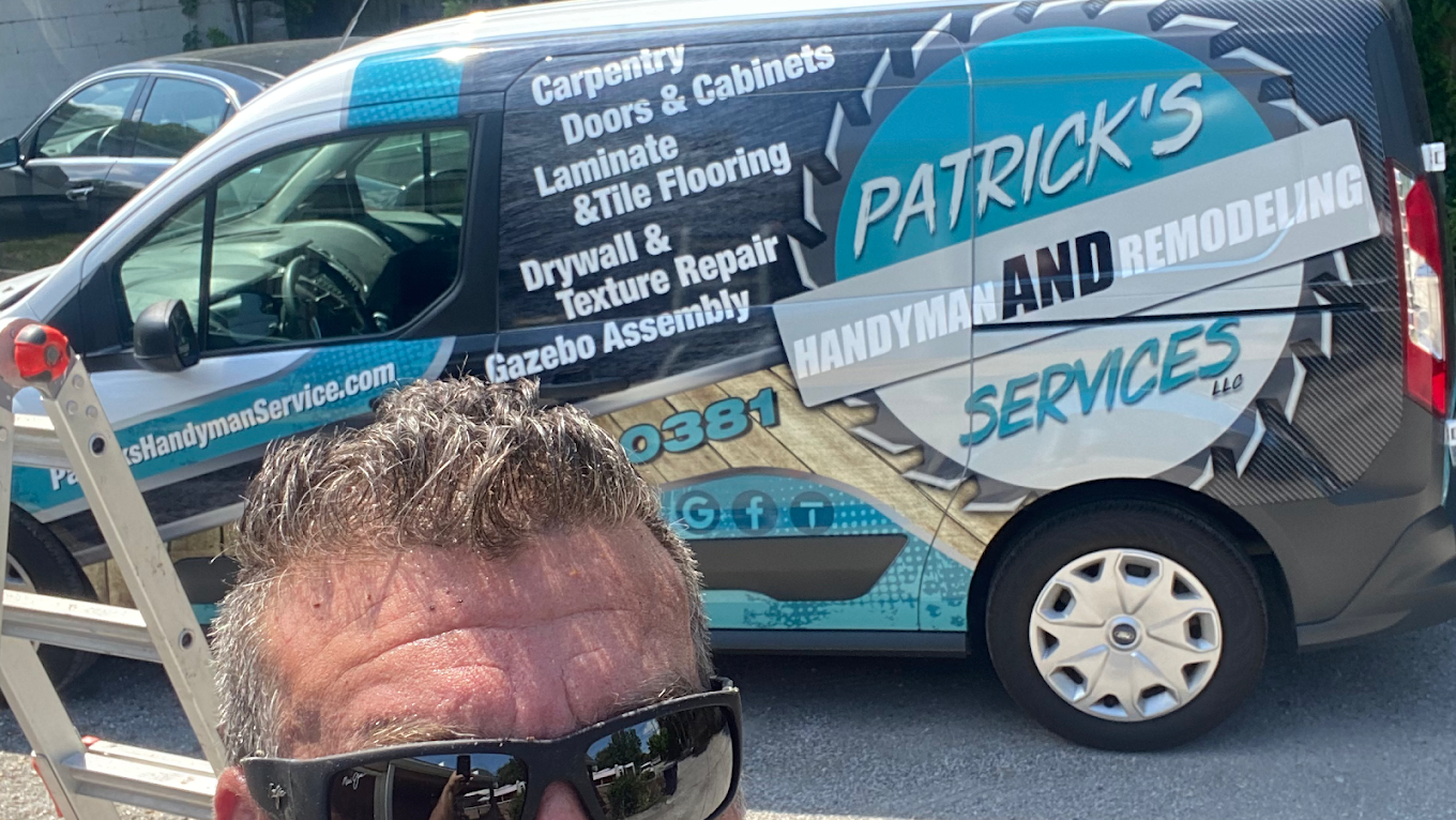 Close-up of the Patrick's Handyman and Remodeling van wrap showing services offered